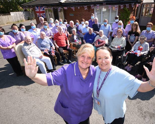 MBE awardee Julie Shield, Abbeyvale Care Centre manager, and Caron Cook,regional operations manager, celebrate with care home residents./Photo: Ian McClelland