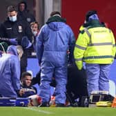 Marcus Browne of Middlesbrough receives medical treatment during the FA Cup Third Round match between Brentford and Middlesbrough.