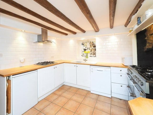 A second peek at the classy kitchen, which is fitted with a range of matching wall and base units, complete with complementary work surfaces. There's an inset one-and-a-half bowl sink and drainer unit, and space for an under-counter fridge.
