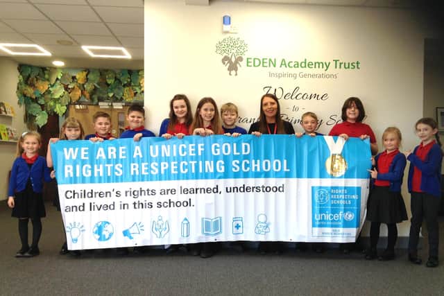 Stranton Primary School Rights Respecting and School Council Lead Louise Yildirim and School Council children proudly showing off their new Gold Award banner.