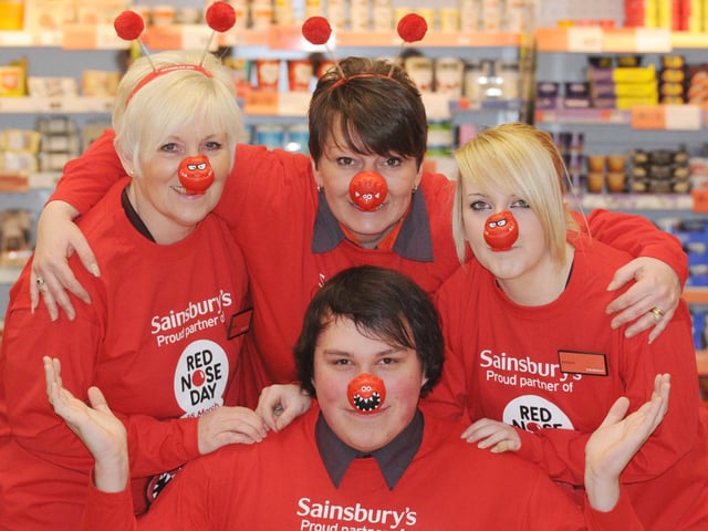 David Clarke, Sue Wenn, Vicky Docherty and Amber Vaughan pictured with some of the Comic Relief merchandise that's on sale at the Middle Warren Sainsbury's store in 2009.