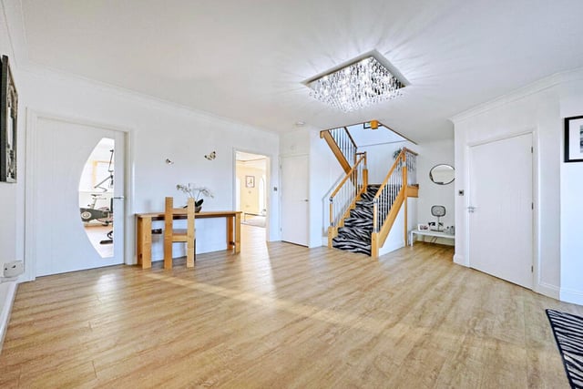 This home has a large and spacious entrance hall that leads to the rest of the house and has stairs leading to the first floor.