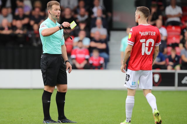 Referee Anthony Backhouse shows a yellow card to Ash Hunter. Salford finished with 83 yellows and five red cards.