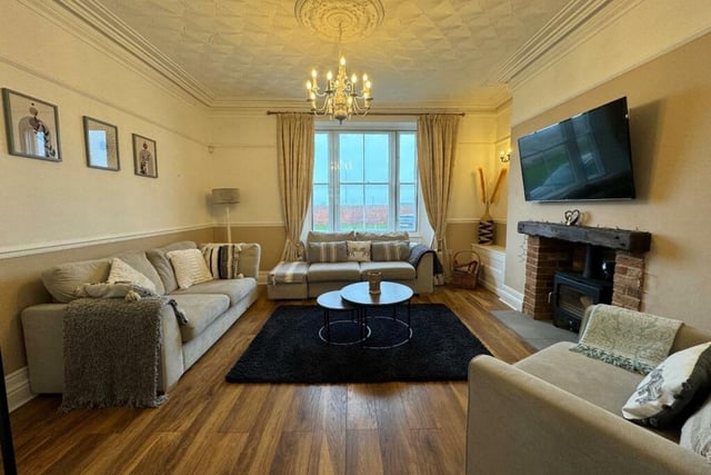 This home has a large lounge featuring a log burner and glass panelled doors leading to the dining room.