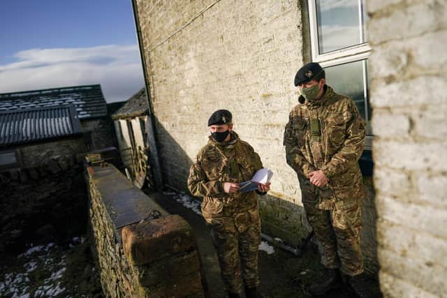 DURHAM, ENGLAND - DECEMBER 05: Craftsman Emily Heavisive (L) and Trooper Josh Harvey from the Royal Lancers carry out a welfare check on a remote property that remains without power in Teesdale on December 05, 2021 in Durham, England. Several thousand people in the North East remain without power more than a week after Storm Arwen battered parts of England and Scotland. As the area faces another bout of wet and windy conditions, members of the British Army's Royal Lancers, a cavalry regiment, are conducting welfare checks on affected residents. (Photo by Ian Forsyth/Getty Images)