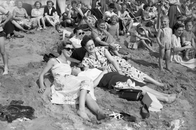Locals and tourists bathe on the beach at Fish Sands in 1954.