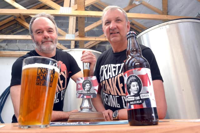 The Crafty Monkey Brewing Company owners Pat Garrett and Gary Olvanhill with bottles of the new God Save The Queen pale ale.