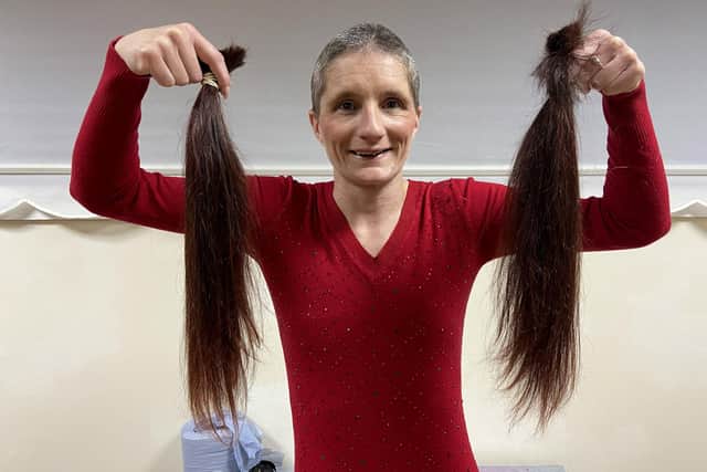 Rachel Jones holds her hair after her headshave Picture by FRANK REID