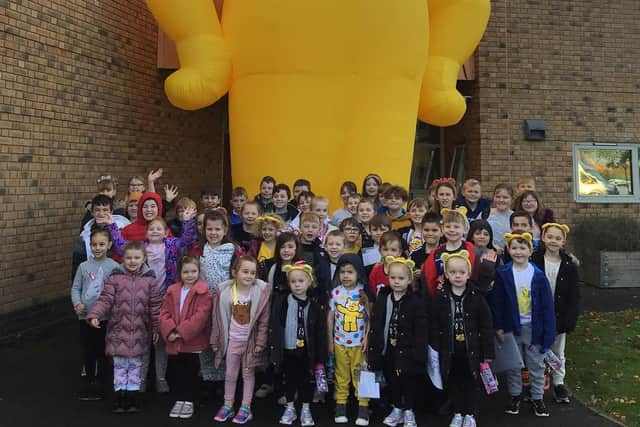Jesmond Gardens Primary School pupils with the 23 feet tall inflatable Pudsey Bear.