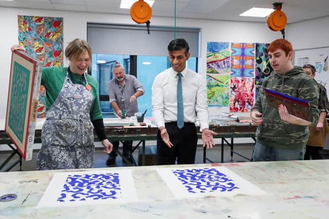 Prime Minister Rishi Sunak looks at his screen-printing during a visit to Northern School of Art.