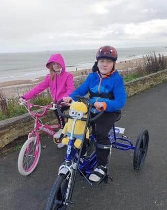 Ellis Butterfield on his new bike with his sister Grace.