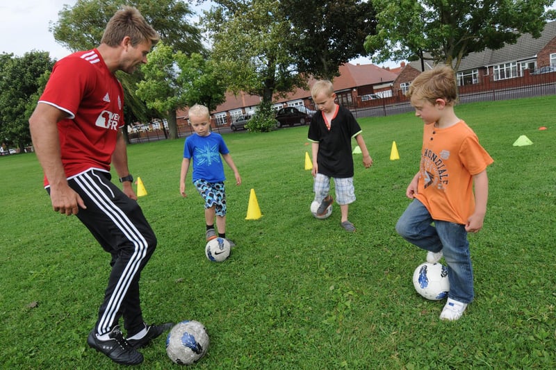 Arron Davies, 5, his brother Raife, 7, from Hendon and Rhys Lamb, 5, from Seaham are pictured improving their football skills with help from staff from the Foundation of Light as part of Sunderland's 2012 activity programme.