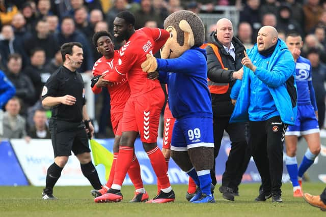 Ayo Obileye of Ebbsfleet United is restrained by Jermaine McGlashan and Hartlepool United mascot H'angus after the Vanarama National League match between Hartlepool United and Ebbsfleet United at Victoria Park, Hartlepool on Saturday 7th March 2020. (Credit: Mark Fletcher | MI News)