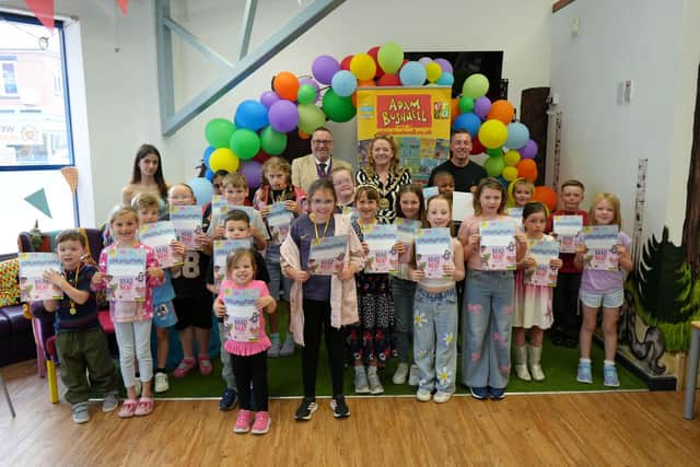 Some of the Summer Reading Challenge champions with their medals and certificates with Mayor Sue Little, consort Paul Little and author Adam Bushnell.