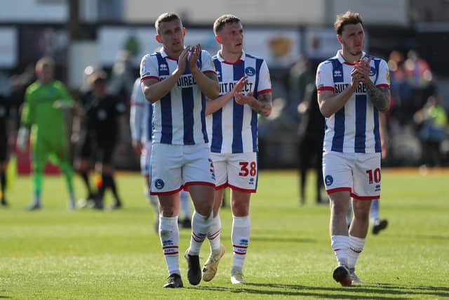 Hartlepool United's David Ferguson, Oliver Finney and Callum Cooke applaud their travelling fans after their 2-0 defeat at Newport County. (Photo: Mark Fletcher | MI News)