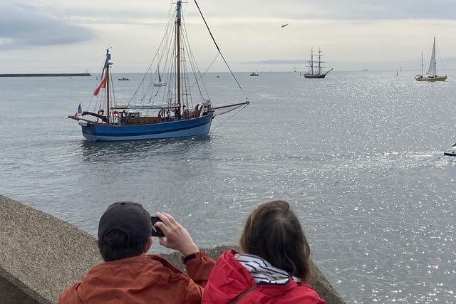 A couple watch the ships head out of port. Picture by FRANK REID