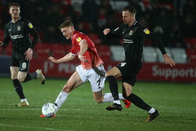 Luke Armstrong of Salford City goes to ground under the challenge of Chris Lines of Northampton Town during the Sky Bet League Two match between Salford City and Northampton Town at The Peninsula Stadium on January 11, 2020 in Salford, England. (Photo by Pete Norton/Getty Images)