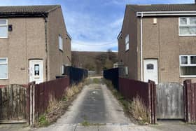 Bollards will shortly be placed between these two homes to prevent fly-tippers from driving down the lane to dump their waste.