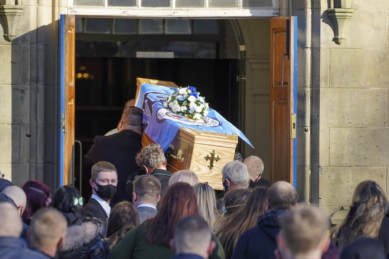 Many mourners arrived at the church carrying blue flowers as a tribute to Lewis.