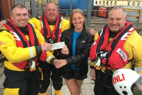 Tori Day presenting the cheque for £400.00 to Hartlepool RNLI volunteer crew members, left to right, James Whyte, Mark Crangle and Darren Killick.