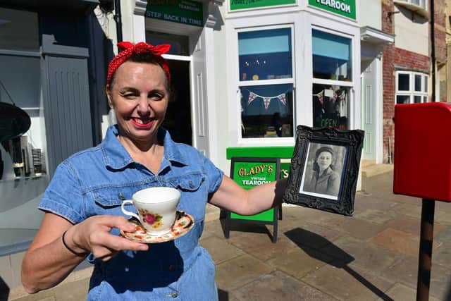 Jacky Sullivan owner of Glady's Vintage Tea room, holding a photograph of her nana Mary Hunter.  Picture by FRANK REID