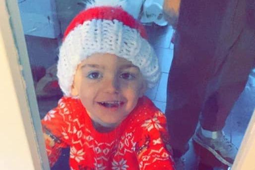 Clayton, age 4, could be on hand to help Santa this Christmas. They have matching hats!