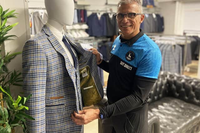 Hartlepool United manager Keith Curle checks out a suit after performing the opening of the Suit Direct store at Powlett Road, Hartlepool. Picture by FRANK REID