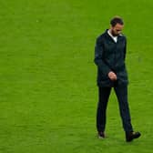 Gareth Southgate, Head Coach of England looks dejected as he walks across the pitch.
