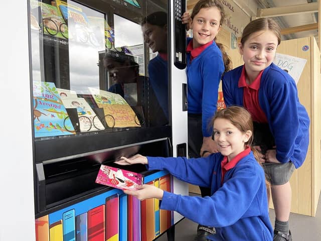 Throston Primary School pupils Eloise Grimston, Isabelle Hicks and Marie Gofton cashing in their book tokens at the book machine within the school. Pictures by FRANK REID.
