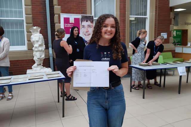 Mia Robertson, 18, with her exam results. She achieved three A*s in chemistry, physics and maths as well as an A in further maths.