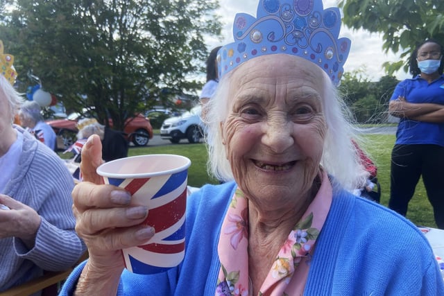 Edith Hartley raises her glass in a toast to The Queen. Cheers, Edith!