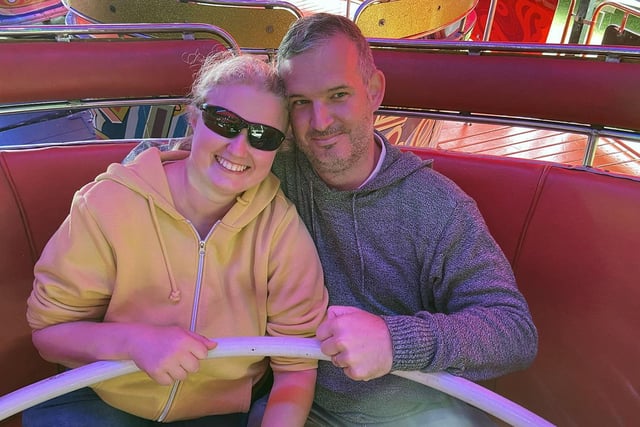 A couple enjoy a wild ride on the waltzers