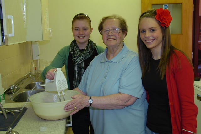 Jamie-Lee Sickling and Ami Ford give a helping hand to Heriot Grange resident Betty Anderson in 2010.