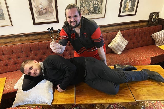 Jason Boobyer with his darts as fellow 24-hour charity marathon player Steve Banner catches up on some much needed sleep in 2021.