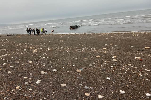 People watched on as work continued to try and pull the vehicle out of the sea. Photo by Kelly Nelson.