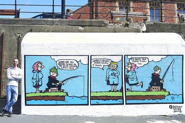 Artist Lewis Hobson by his Andy Capp cartoon strip mural near the Pilot Pier on the Headland. Picture: Tom Collins.