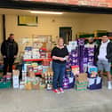 Hartlepool Foodbank coordinator Lisa Lavender with Apparel FC manager Jonathon Bull (second from left) and other players presenting food bought with money raised by Hartlepool Sunday League.