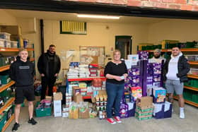 Hartlepool Foodbank coordinator Lisa Lavender with Apparel FC manager Jonathon Bull (second from left) and other players presenting food bought with money raised by Hartlepool Sunday League.