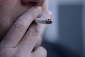 A man smoking a cigarette.