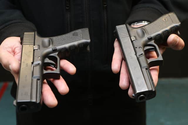 One of these Glock 17 pistols is a Police issue side arm the other is a plastic BB gun and even the officers cannot tell them apart without handling them