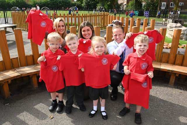 A sales advisor from the nearby David Wilson Homes Elwick Gardens development, gifts pupils with new school uniforms.