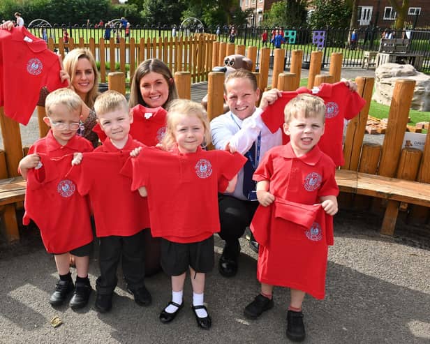 A sales advisor from the nearby David Wilson Homes Elwick Gardens development, gifts pupils with new school uniforms.