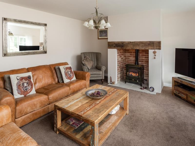 Cosy and spacious, the lounge is flooded with natural light from the windows to the front and benefits from a feature fireplace housing a living flame gas stove, inset in the chimney breast with an exposed brick back.