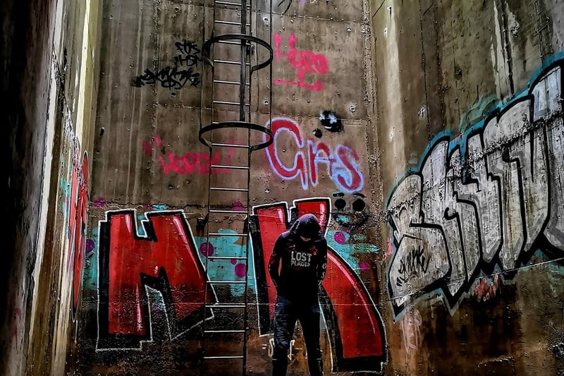 An urban explorer stands at the north portal exit chamber.