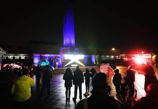 Victory Square war memorial was lit up in the colours of Ukraine’s flag ahead of a short act of reflection.​