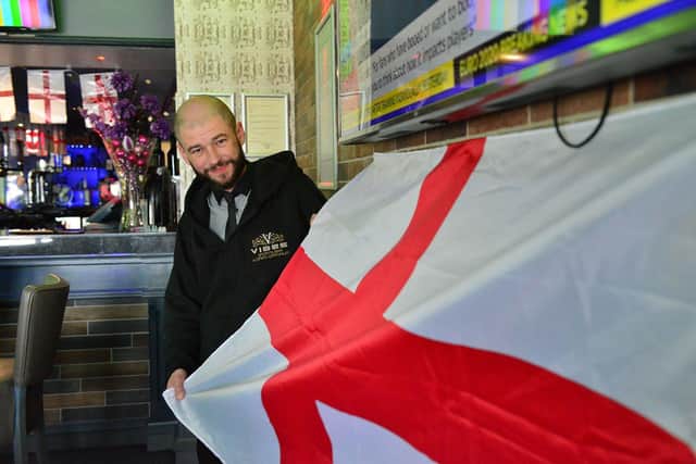 Leeroy Newsome, the general manager at Vibes sports bar, in Navigation Point, Hartlepool Marina, which has been decked out with flags to mark the start of the Euro 2020 football tournament.