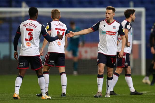 Liam Gordon and Tom White of Bolton Wanderers high five during the EFL Trophy match between Bolton Wanderers and Newcastle United U21 at University of Bolton Stadium on November 17, 2020 in Bolton, England. (Photo by Charlotte Tattersall/Getty Images)