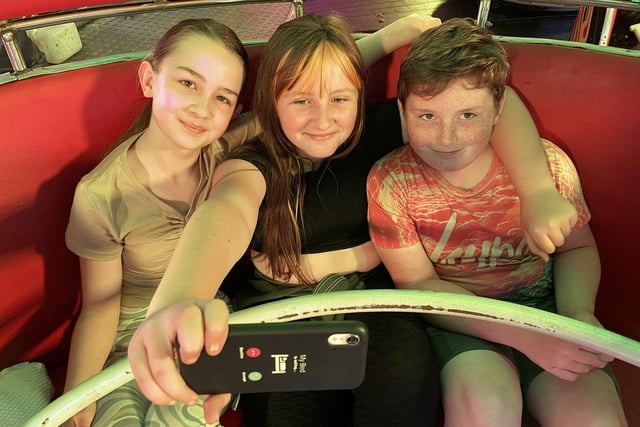 Youngsters taking a selfie on the waltzers.
