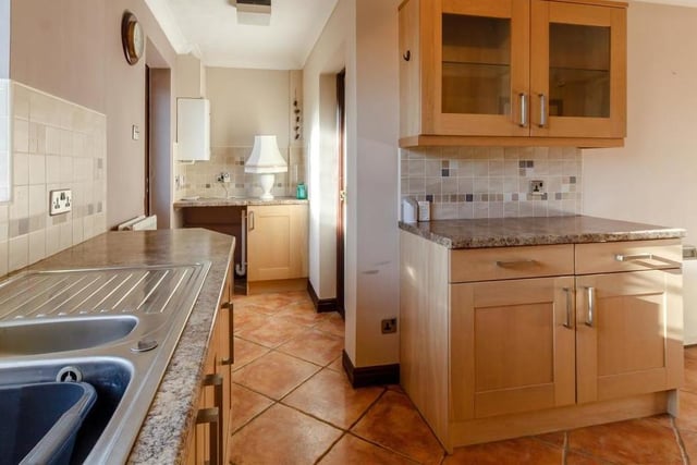Just off the kitchen is this useful utility area, which has plumbing for a washing machine. It also contains work surfaces and storage space, and houses a wall-mounted Worcester gas-fired, central heating boiler.
