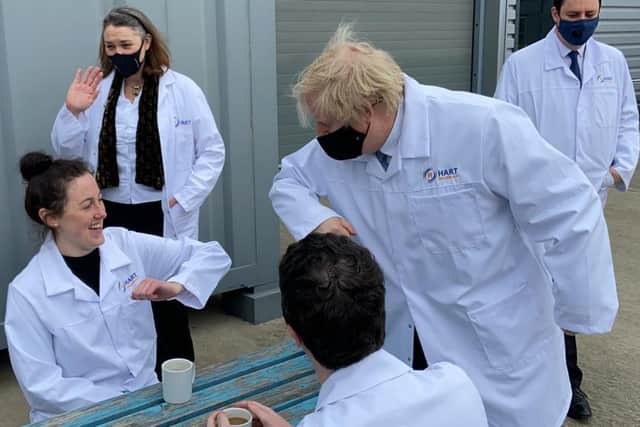 Boris Johnson greets Hart Biologicals worker Kensey Robinson by touching elbows during his visit to the Hartlepool business on Thursday.
